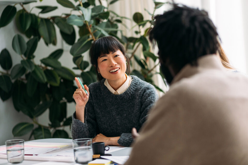 Woman engaging in a discussion during a meeting.