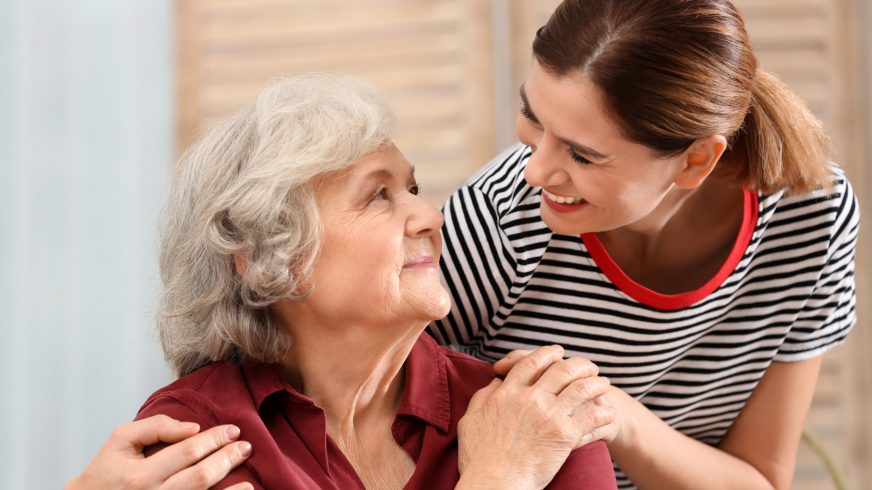 Elderly woman with female caregiver at home