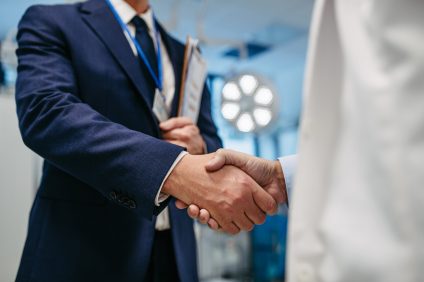 Pharmaceutical Sales Representatives shaking hands.