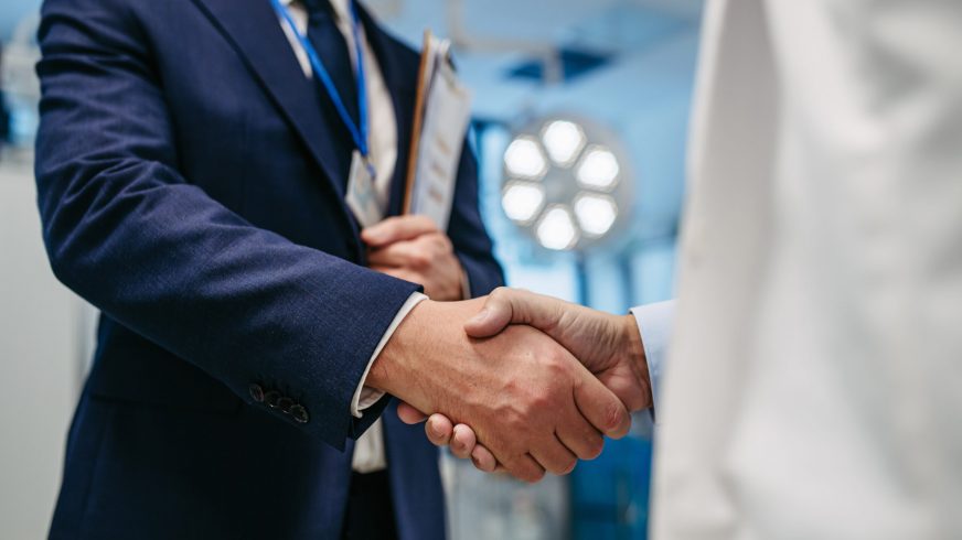 Pharmaceutical Sales Representatives shaking hands.